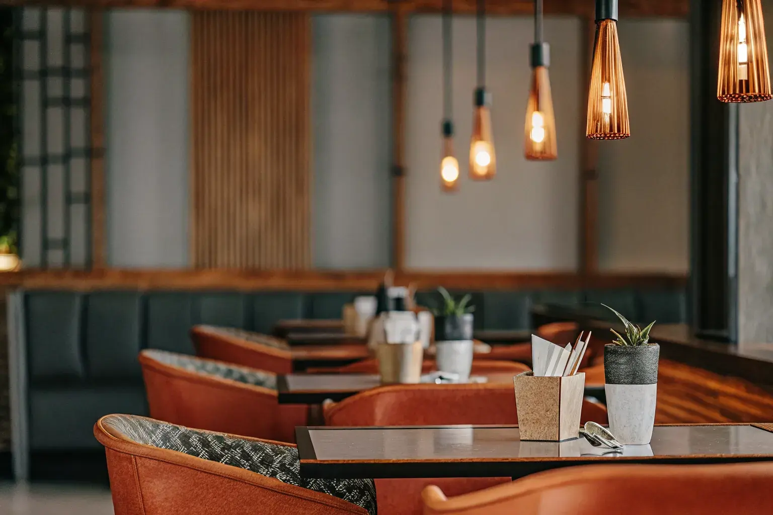 Upscale restaurant dining room set with eco-friendly compostable serviceware, representing the hospitality sustainability program