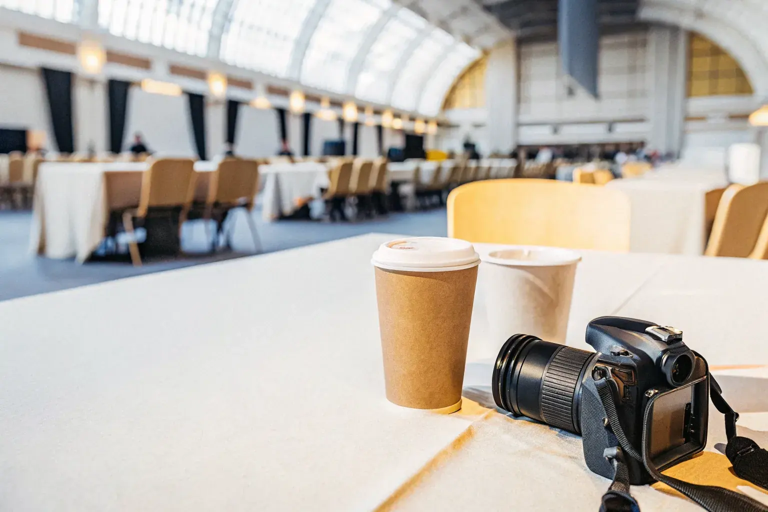 Grand convention center interior with compostable eco-friendly serviceware for institutional venue sustainability