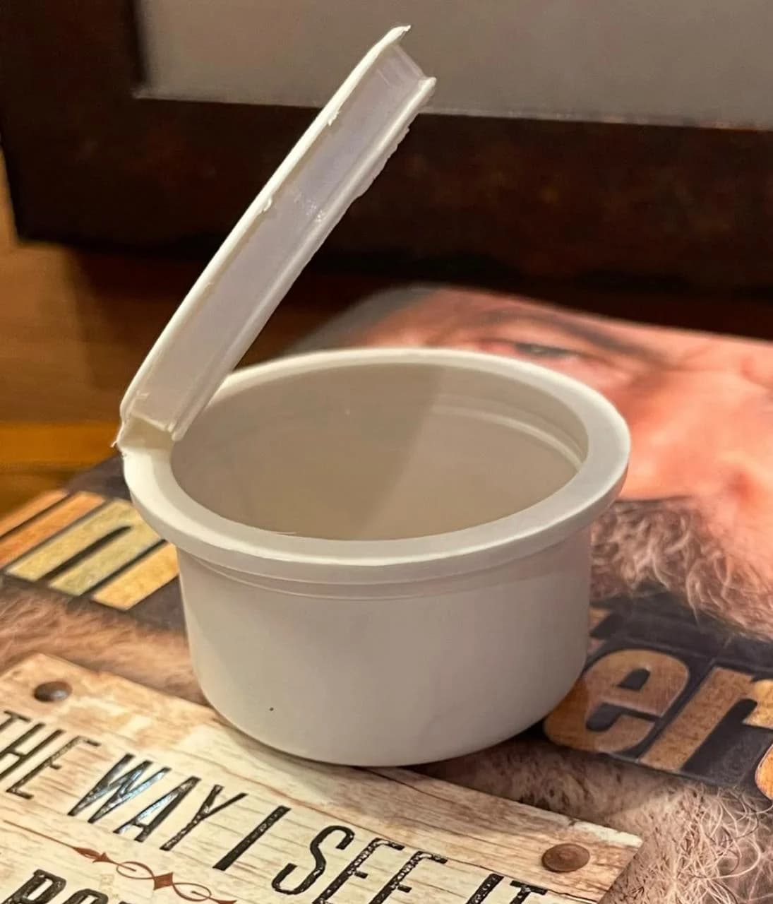 Biodegradable PHA pop top container with hinged flip-top lid